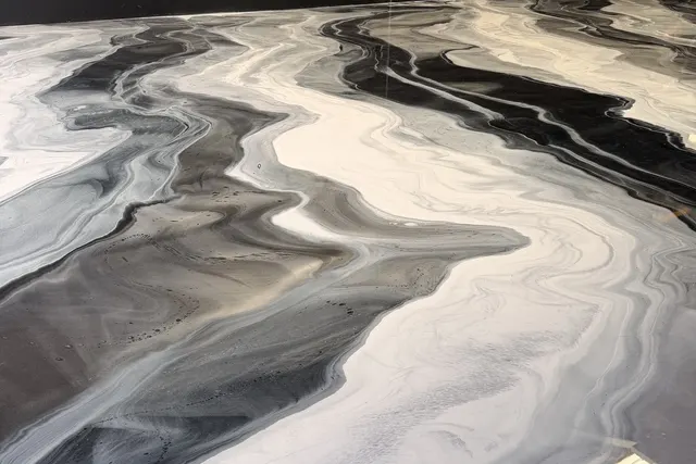 Black, grey and white metallic epoxy floor poured like marble