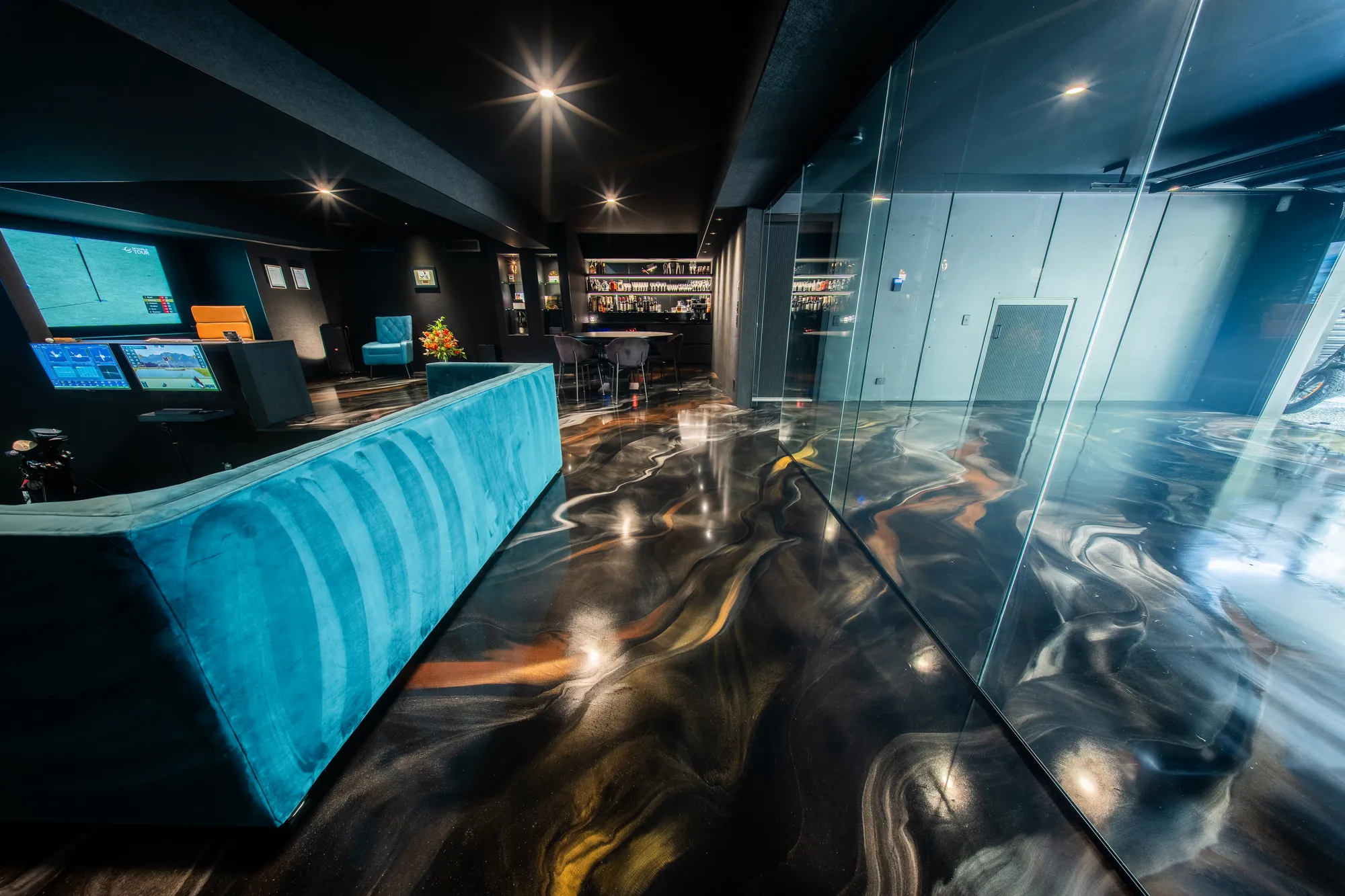 Copper and black metallic epoxy floor in a recreation room at Gilston