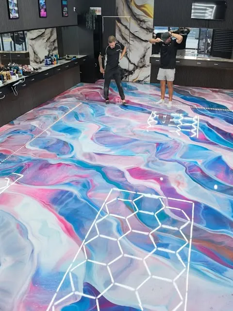 Pink and blue metallic floor at Vice City Barbers